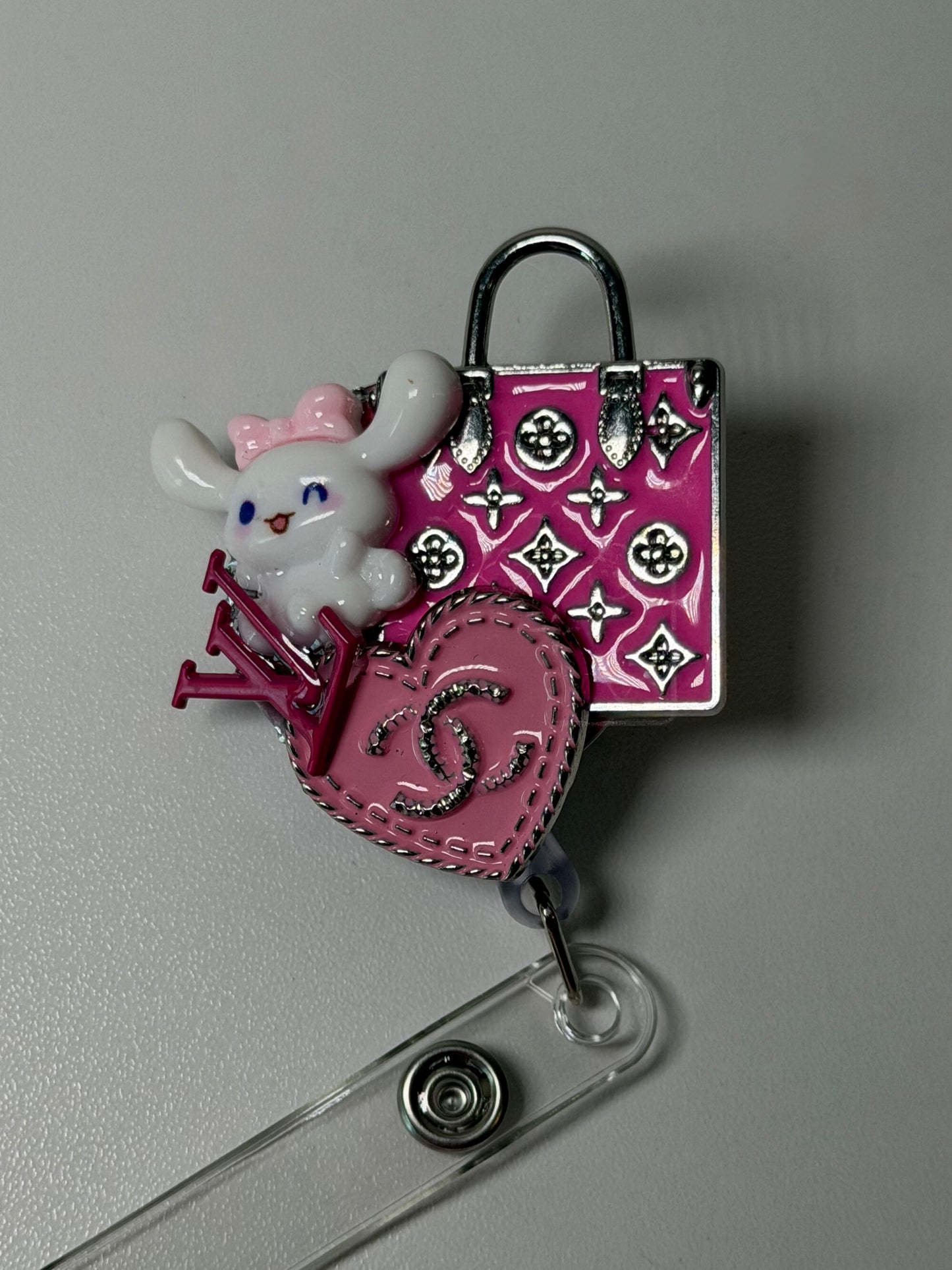 LV PURSE BADGE REEL